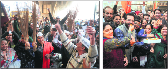 Supporters of the Aam Aadmi Party (left) and the BJP celebrate the victory of the parties in the Assembly elections, in Ludhiana on Sunday.