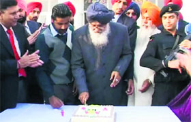Chief Minister Parkash Singh Badal cuts his birthday cake at Badal village on Sunday.
