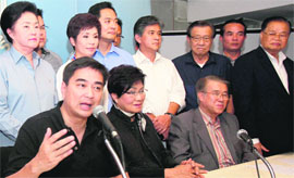 Thailand's opposition leader Abhisit Vejjajiva (left) addresses mediapersons in Bangkok on Sunday.