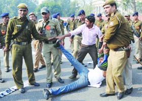 Delhi police detain civil services aspirants during their protest outside Parliament against the new examination pattern of the UPSC, in New Delhi on Monday