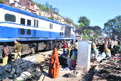 Encroachments being removed from the railway line near Brahampuri colony in Haridwar on Monday. Tribune photo: Rameshwar Gaur