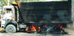 A dumper set ablaze by residents of Tikola village in Sonepat on Monday. Photo by writer