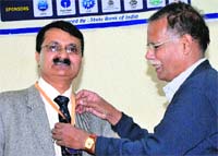 Dr Pawan K Sharma (left) receives the Professor DP Chakraborty 60th birth anniversary commemoration award 2012 at Panjab University, Chandigarh. a tribune photograph