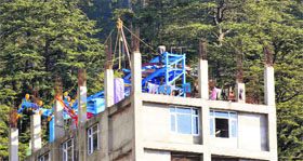 Construction work continues on the Jakhoo ropeway in Shimla on Monday.
