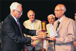Governor NN Vohra presents an award to a teacher at the golden jubilee celebrations of the Shrimati Dewanini Vidyavati Badrinath Educational Trust at General Zorawar Singh Auditorium in Jammu.