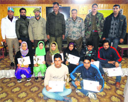 Winners and runners-up of the range-level Carom and Chess Championship with senior police officials in Srinagar on Monday. 