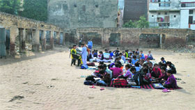 In the absence of rooms with roofs, students of Government Primary School, Field Ganj, Ludhiana, are forced to study in the open.
