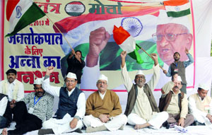 Supporters of social activist Anna Hazare sitting on dharna at Jantar Mantar in New Delhi on Tuesday as Hazare begins an indefinite fast for the Jan Lokpal Bill at his village in Maharashtra.