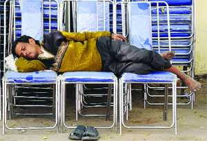 A man lies on the chairs during a wedding ceremony in New Delhi on Tuesday.