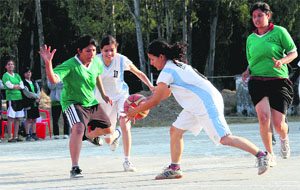 A match in progress in the District Basketball Open and Under-19 Girls Tournament played at Parade Ground in Dehradun on Tuesday. 