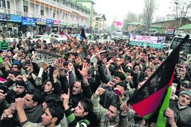 Supporters of MLA Engineer Rashid raise slogans during a protest