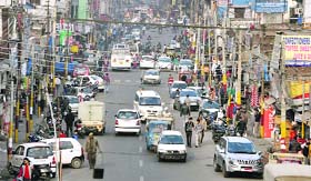 Wrong parking and encroachments by shopkeepers on the Rajindra Market road cause problems for commuters in Jammu