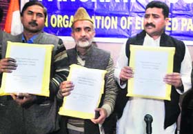 Members of the All Jammu and Kashmir Panchayat Conference display the letter written to MPs in Jammu on Tuesday