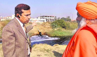 Environment engineer SP Garg and Baba Balbir Singh Seechewal, a member of the Punjab Pollution Control Board, discuss a point at the site where a pipe was found discharging effluents into a drain, crossing Leather Complex, in Jalandhar on Tuesday.