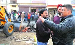 Assistant Town Planner Rajinder Sharma (extreme right) during a demolition drive of the MC in Ludhiana on Tuesday. Tribune Photo: Himanshu Mahajan
