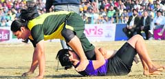 A Pakistan raider tries to free herself from the hold of a Mexican player during their match in the World Cup Kabaddi in Mansa on Tuesday. Tribune Photo: Pawan Sharma