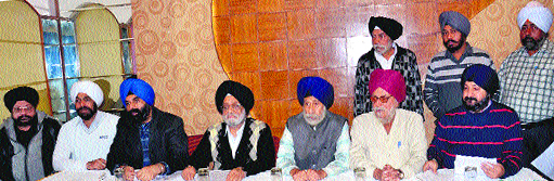 Members of the Golden Temple Complex Shopkeepers Association address a press conference in Amritsar on Wednesday.
