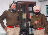 Outgoing SSP Naunihal Singh (left) and new SSP Sukhchain Singh Gill at the police headquarters in Sector 9, Chandigarh, on Wednesday. A Tribune photograph