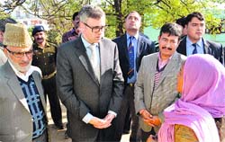Chief Minister Omar Abdullah interacts with a beneficiary of the Umeed scheme in Udhampur on Wednesday. A Tribune photograph