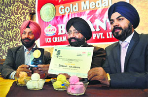 Rajinder Basant (centre) shows the certificate awarded to Basant Ice-creams for winning an event at the Great Indian Ice-cream Contest , at Basant Resorts on Wednesday.