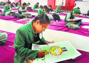 Students take part in a poster-making contest organised at Green Land Public Senior Secondary School in Ludhiana on Wednesday. 