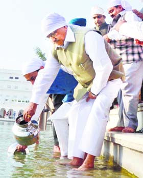 On a mission: Gujarat ministers and MLAs collect holy water from the sarovar of the Golden Temple in Amritsar on Wednesday for the 182-metre Sardar Vallabhbhai Patel Statue of Unity being built in Gujarat