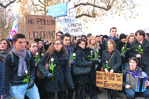 High school students hold white roses at Lyon in France as they protest against French education minister Vincent Peillons law project for the high school.