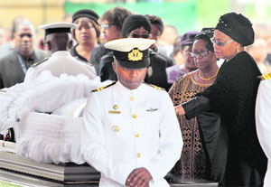 Graca Machel, the widow of former South African President Nelson Mandela, pays her respects at his coffin at the Union Buildings in Pretoria on Wednesday. Mandela's funeral will take place at his ancestral village of Qunu in Cape province on Sunday.