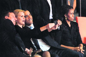 British Prime Minister David Cameron (left) and US President Barack Obama (right) pose for a picture with Denmarks Prime Minister Helle Thorning Schmidt during the memorial service of former South African President Nelson Mandela at Johannesburg on Tuesday