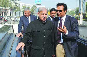 Chief Minister of Pakistan's Punjab state Muhammad Shahbaz Sharif (L) arrives at Rajiv Chowk Metro Station in New Delhi on Thursday