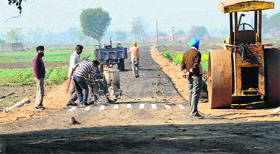An approach road being given finishing touches at Jatti Umra