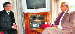 Governor NN Vohra interacts with Chief Information Commissioner GR Sufi at Raj Bhawan in Jammu on Thursday. 