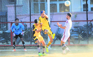 Players in action during a match in the Sher-e Kashmir Gold Cup Football Tournament at GGM Science College in Jammu on Thursday. 