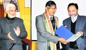 KU Vice Chancellor Talat Ahmad (c) gets an award in Srinagar on Thursday.