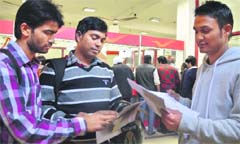 Youths fill forms for vacancies in the Department of Posts in Ludhiana. Photo: Inderjeet Verma