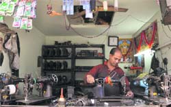 A man repairs a machine at a sewing machine unit in Ludhiana. a file photo