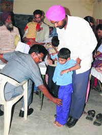 A health expert examines a special child at a camp in Bathinda in August.