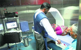 A technician performs dexa scan on the mobile mammography van at Dhanas.