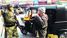 A CRPF personnel stops a commuter during checking in Srinagar on Friday after militants killed a CRPF officer in an attack at the Nowgam bypass on Thursday.