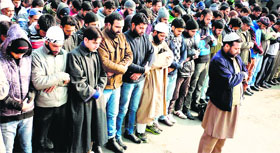 Members of the Muslim community offer prayers in absentia to Abdul Quader Mollah in Srinagar on Friday.