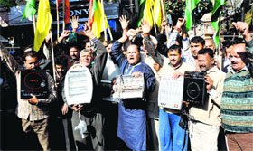 Members of the Dogra Front protest against unscheduled power cuts in Jammu on Friday.