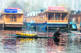 A florist sets out for the days work on the Dal Lake in Srinagar on Friday.
