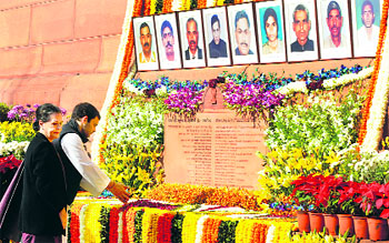 Congress president Sonia Gandhi and Rahul Ganadhi pay tribute to the martyrs of 2001 Parliament attack on its 12th anniversary, at Parliament House in New Delhi on Friday.