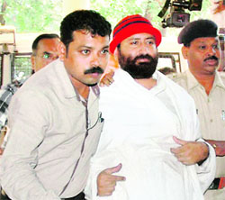 Narayan Sai, accused in a rape case, being produced in court in Surat on Friday
