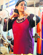 A woman tries an ornament at Wedding Mantra's winter exhibition