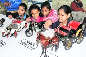 Children take a look at the miniatures on display at the arts exhibition organised by the Punjab Lalit Kala Akademi in Bathinda on Saturday