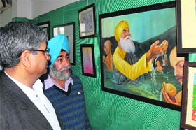 Admirable art: Chief Parliamentary Secretary Sarup Chand Singla admires works on display at the art exhibition organised by the Punjab Lalit Kala Akademi in Bathinda on Saturday