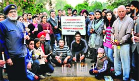 Merchant Navy officers along with their family members hold a candlelight march in support of Capt Sunil James at Sukhna Lake in Chandigarh on Saturday
