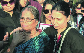 Mother and wife of Captain Sunil James, who is behind bars in a Togo jail, during a protest to press for his release in Mumbai on Saturday.