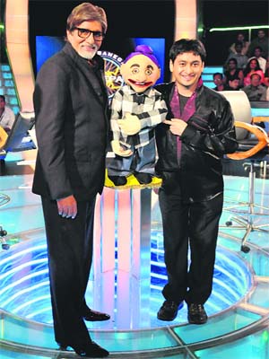 Amitabh Bachchan with one of the contestants on the sets of Kaun Banega Crorepati